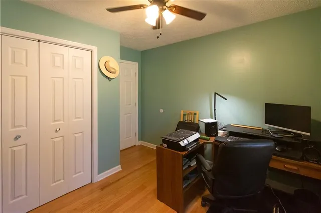 a view of a workspace with furniture and a window