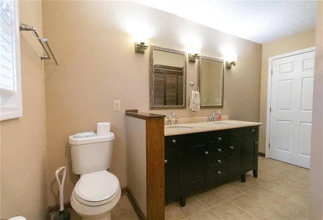 a bedroom with a bed and a ceiling fan