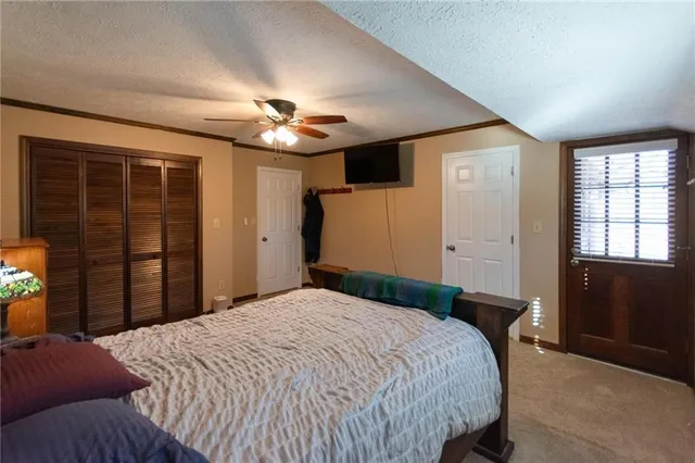 a bedroom with a large bed and a flat screen tv