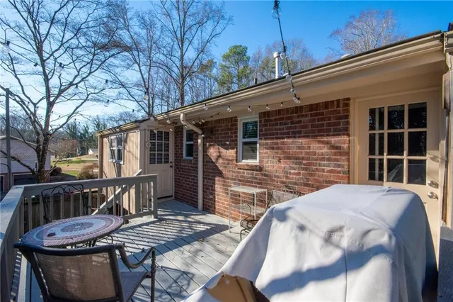 a view of balcony with wooden floor and outdoor seating