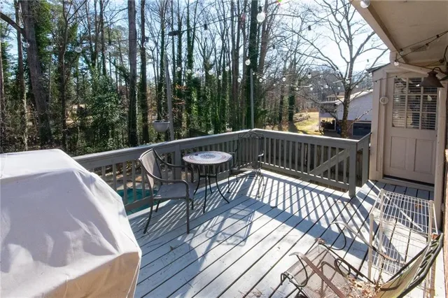 a backyard of a house with table and chairs