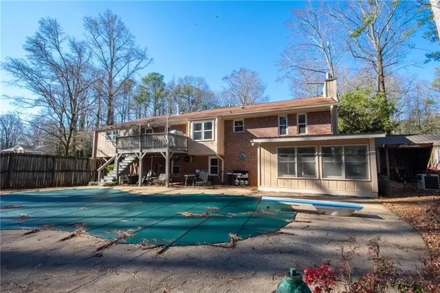 a view of house with yard and seating area