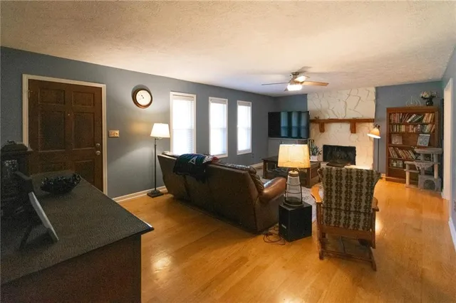a living room with furniture fireplace and flat screen tv