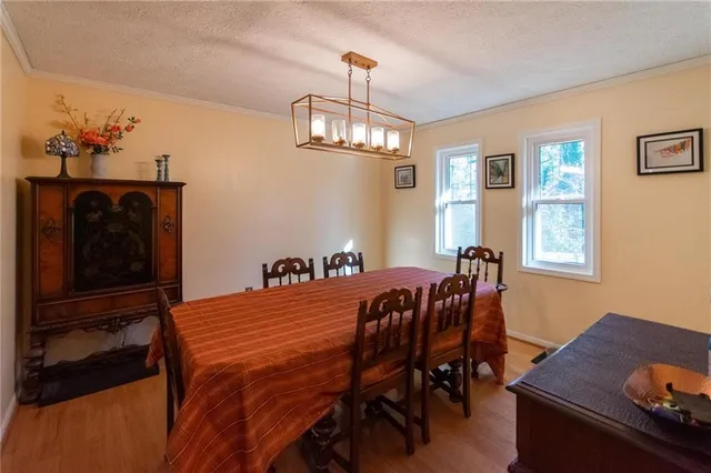a view of a dining room with furniture and chandelier