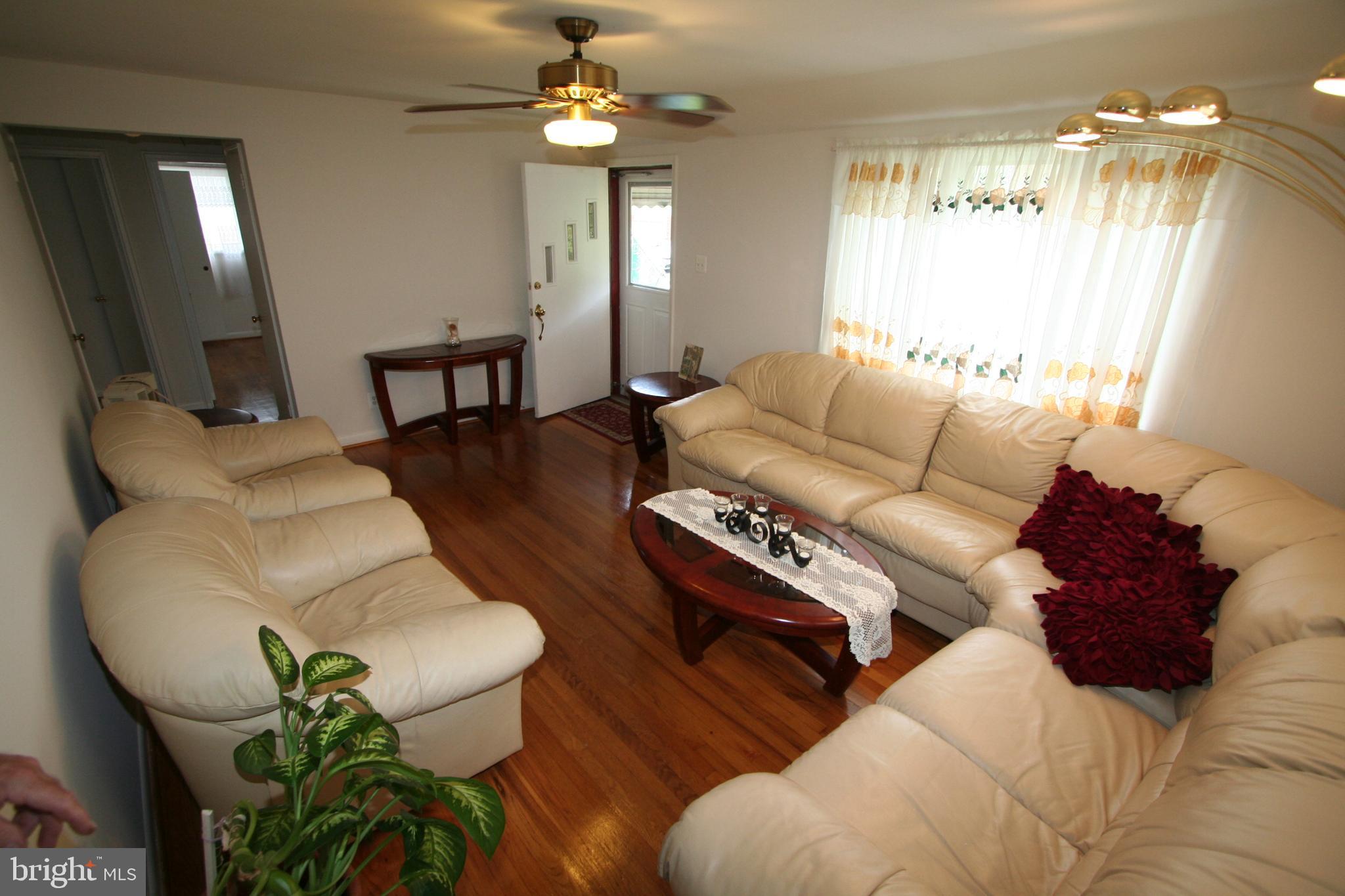 12718 Gould Road Silver Spring, MD 20906 - Photo 11 of 55 a living room with furniture a chandelier and a window