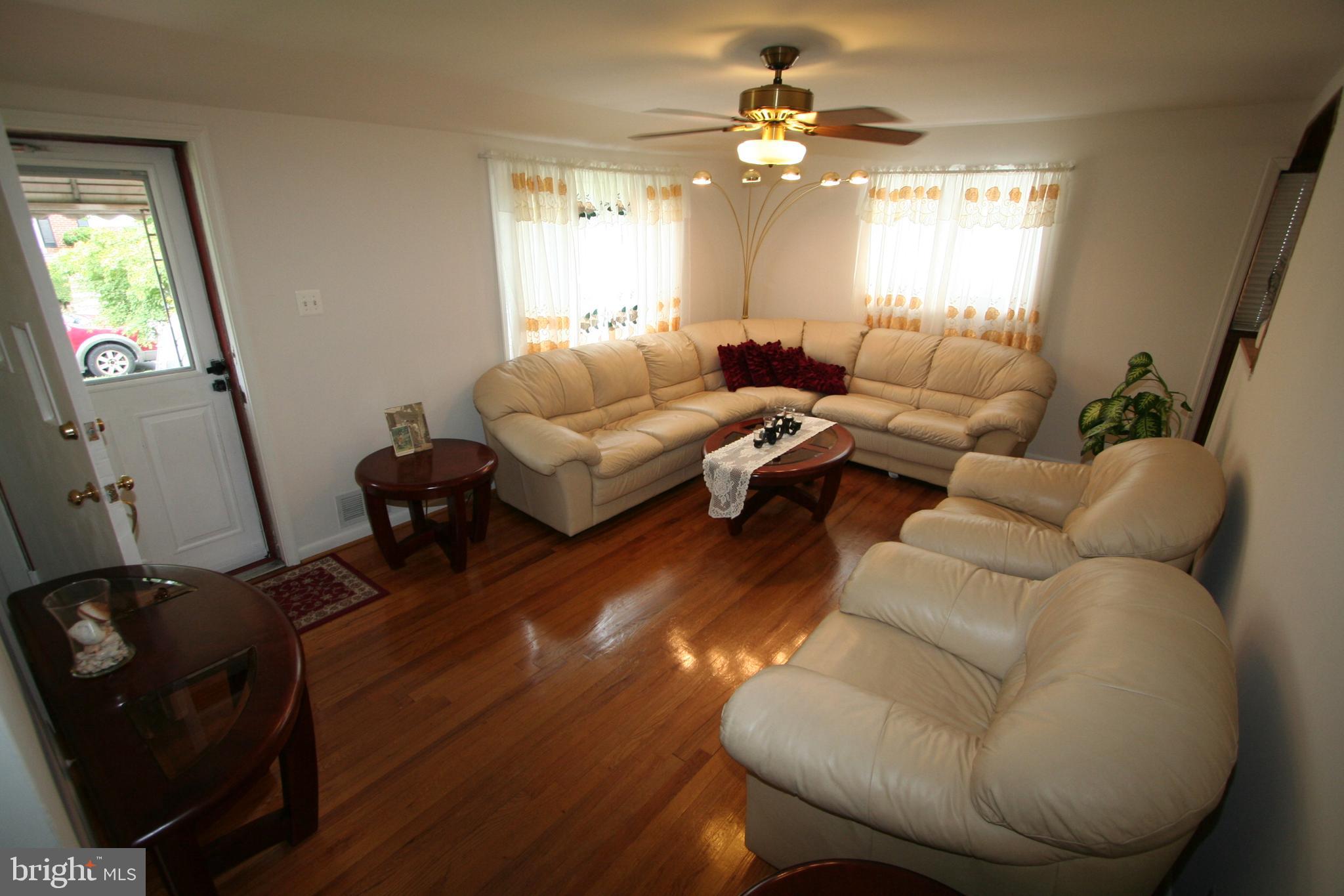 12718 Gould Road Silver Spring, MD 20906 - Photo 12 of 55 a living room with furniture and a chandelier