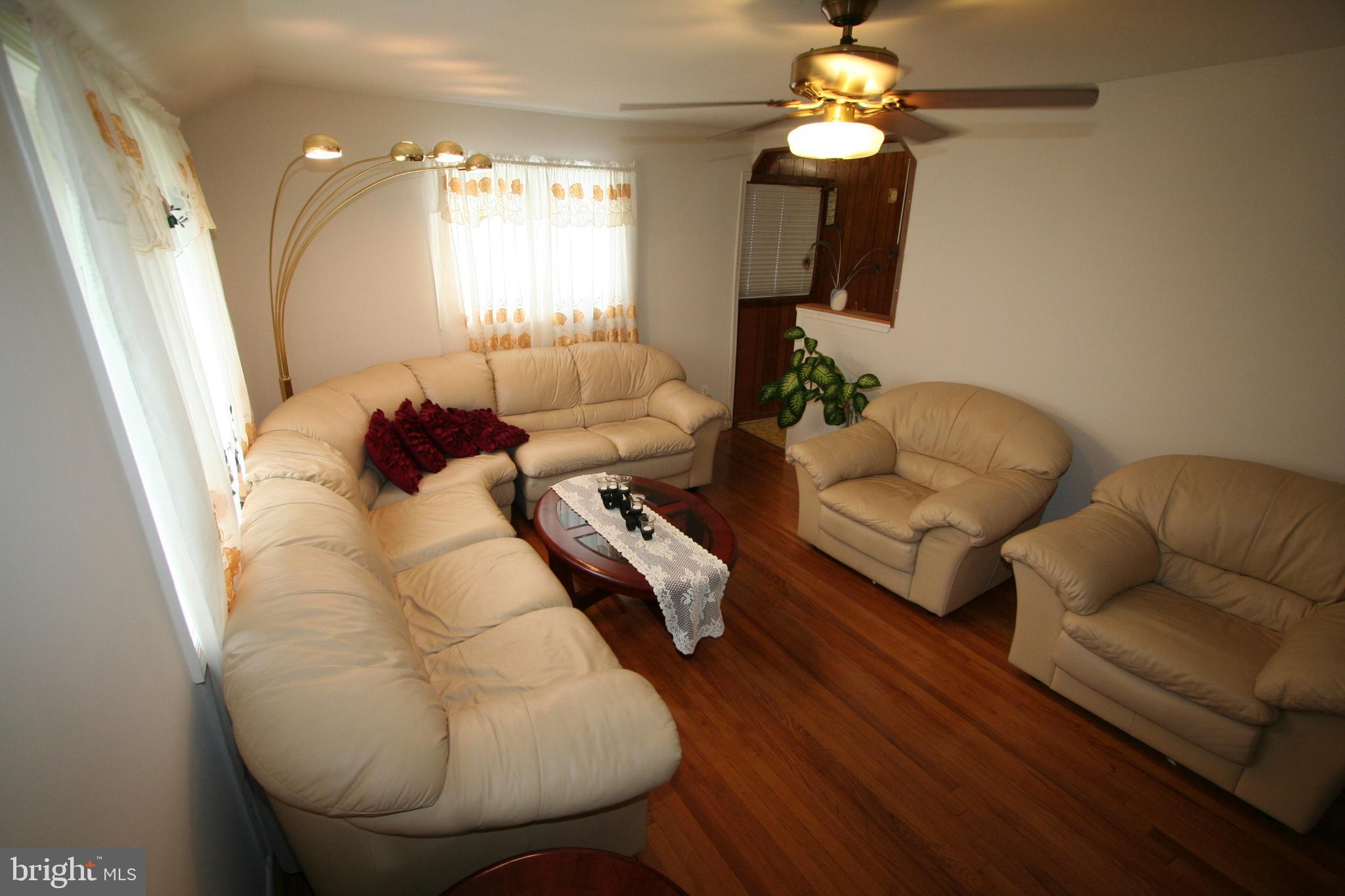 12718 Gould Road Silver Spring, MD 20906 - Photo 13 of 55 a living room with furniture and a chandelier