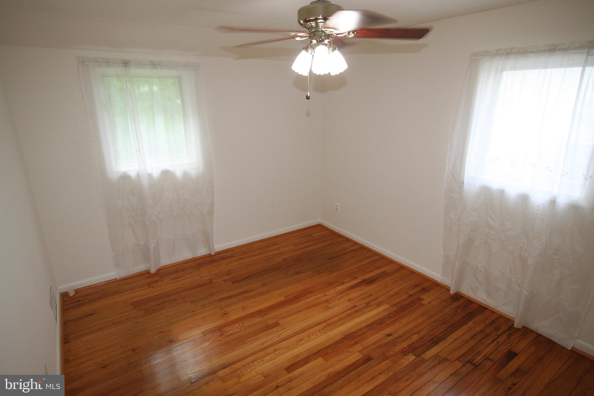 12718 Gould Road Silver Spring, MD 20906 - Photo 16 of 55 a view of empty room with wooden floor