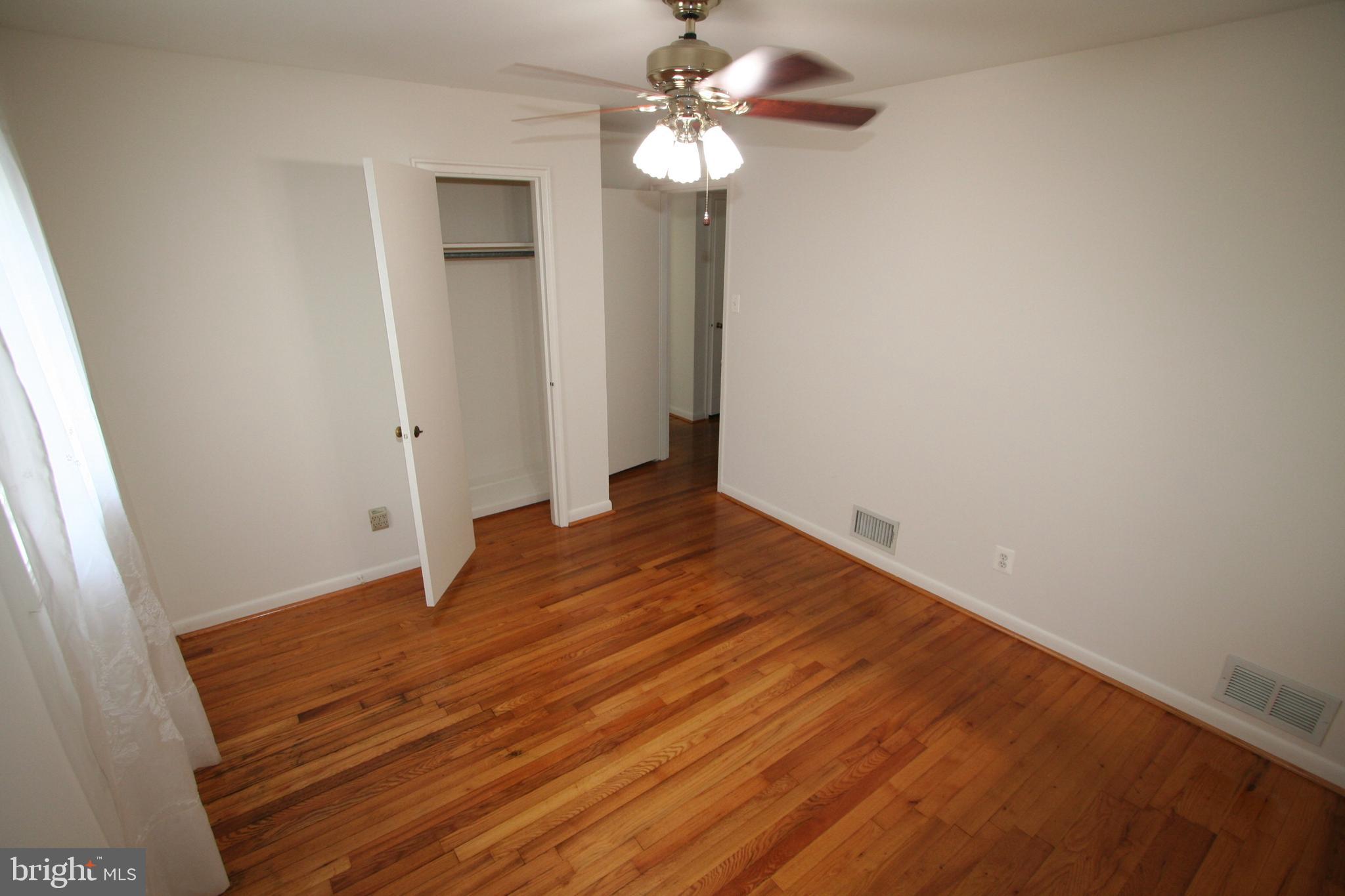 12718 Gould Road Silver Spring, MD 20906 - Photo 18 of 55 wooden floor in an empty room with a window