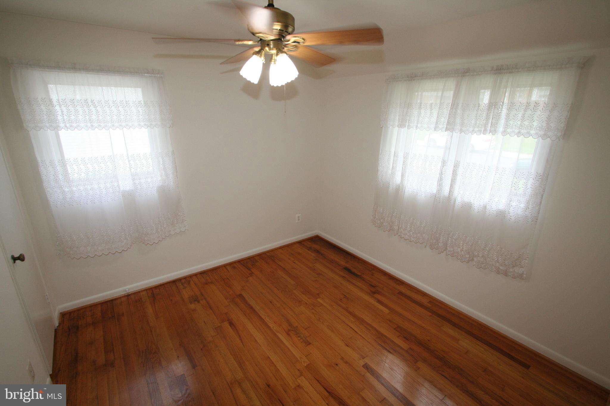 12718 Gould Road Silver Spring, MD 20906 - Photo 19 of 55 wooden floor in an empty room with a window