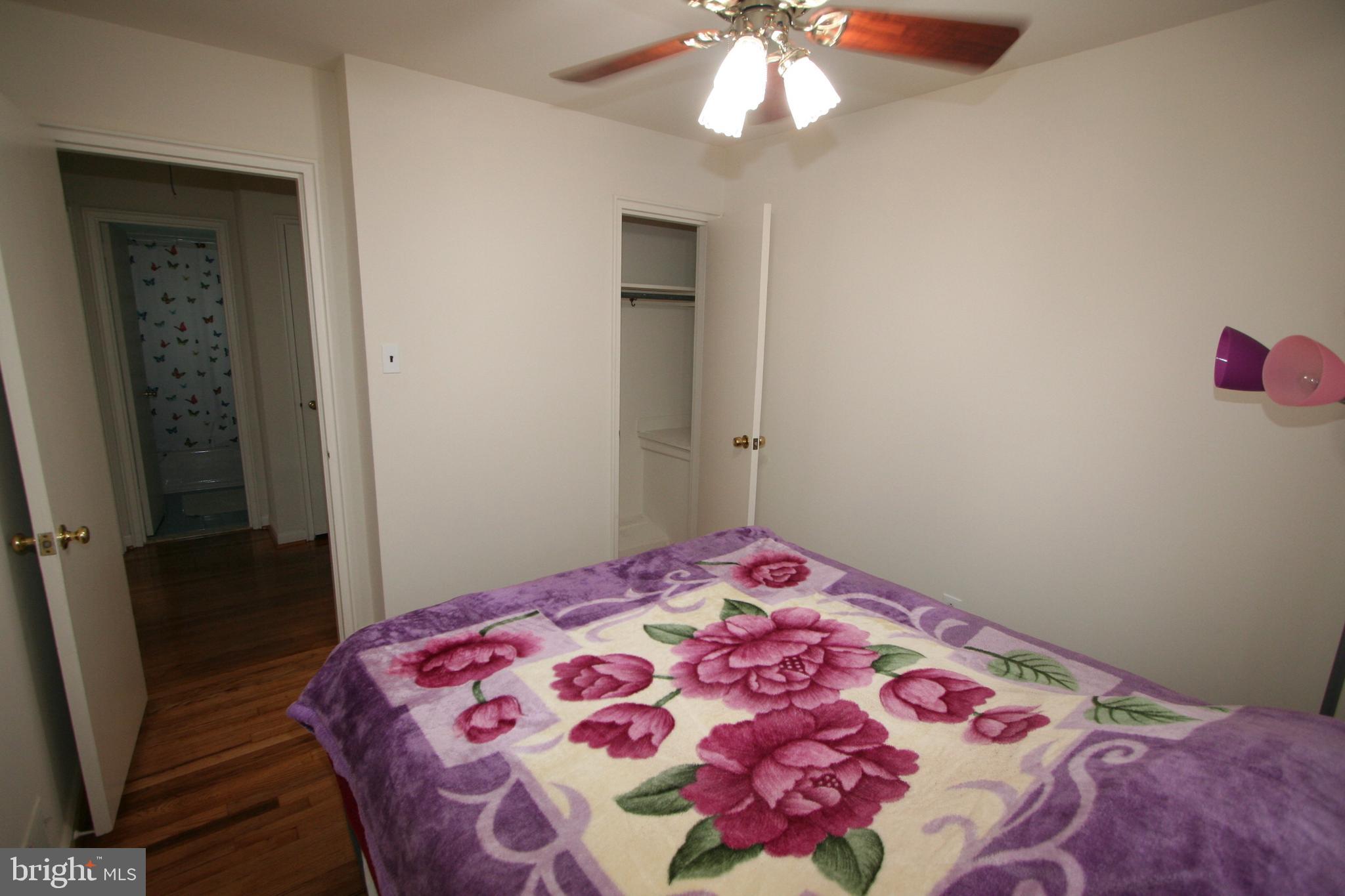 12718 Gould Road Silver Spring, MD 20906 - Photo 22 of 55 a bedroom with a bed and a chandelier