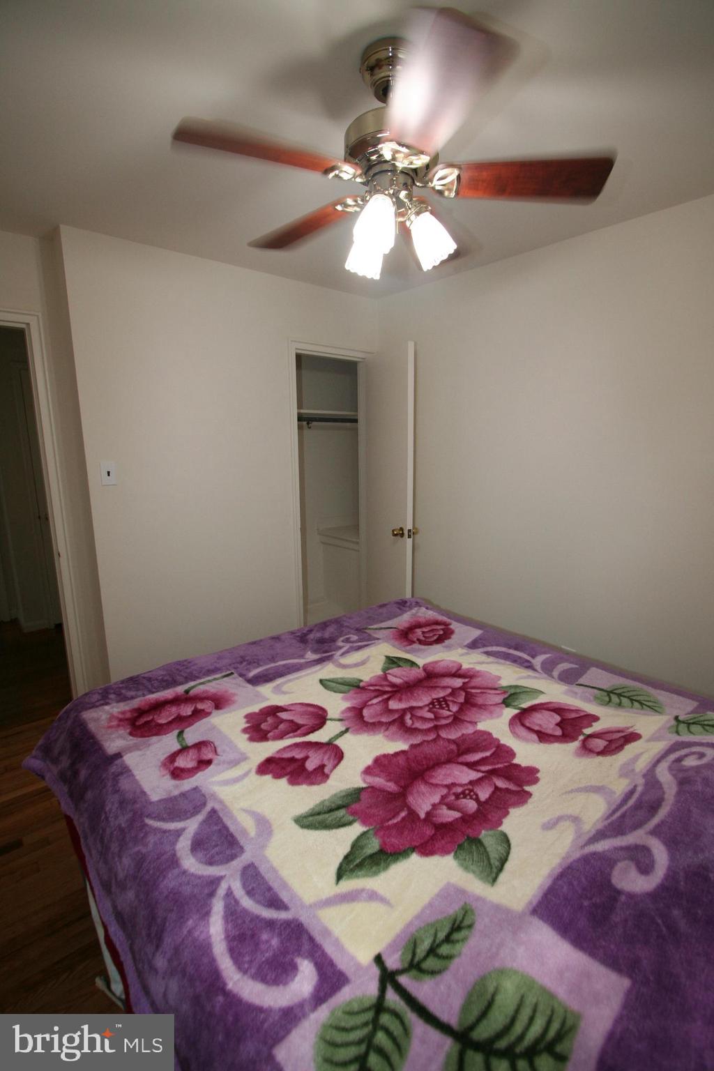 12718 Gould Road Silver Spring, MD 20906 - Photo 23 of 55 a bedroom with a bed and a chandelier