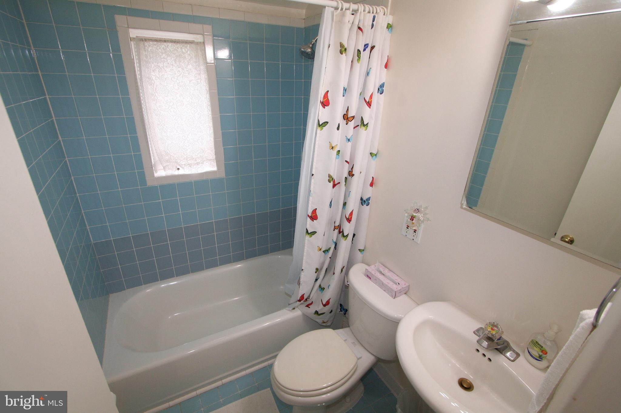 12718 Gould Road Silver Spring, MD 20906 - Photo 24 of 55 a white toilet sitting next to a bath tub