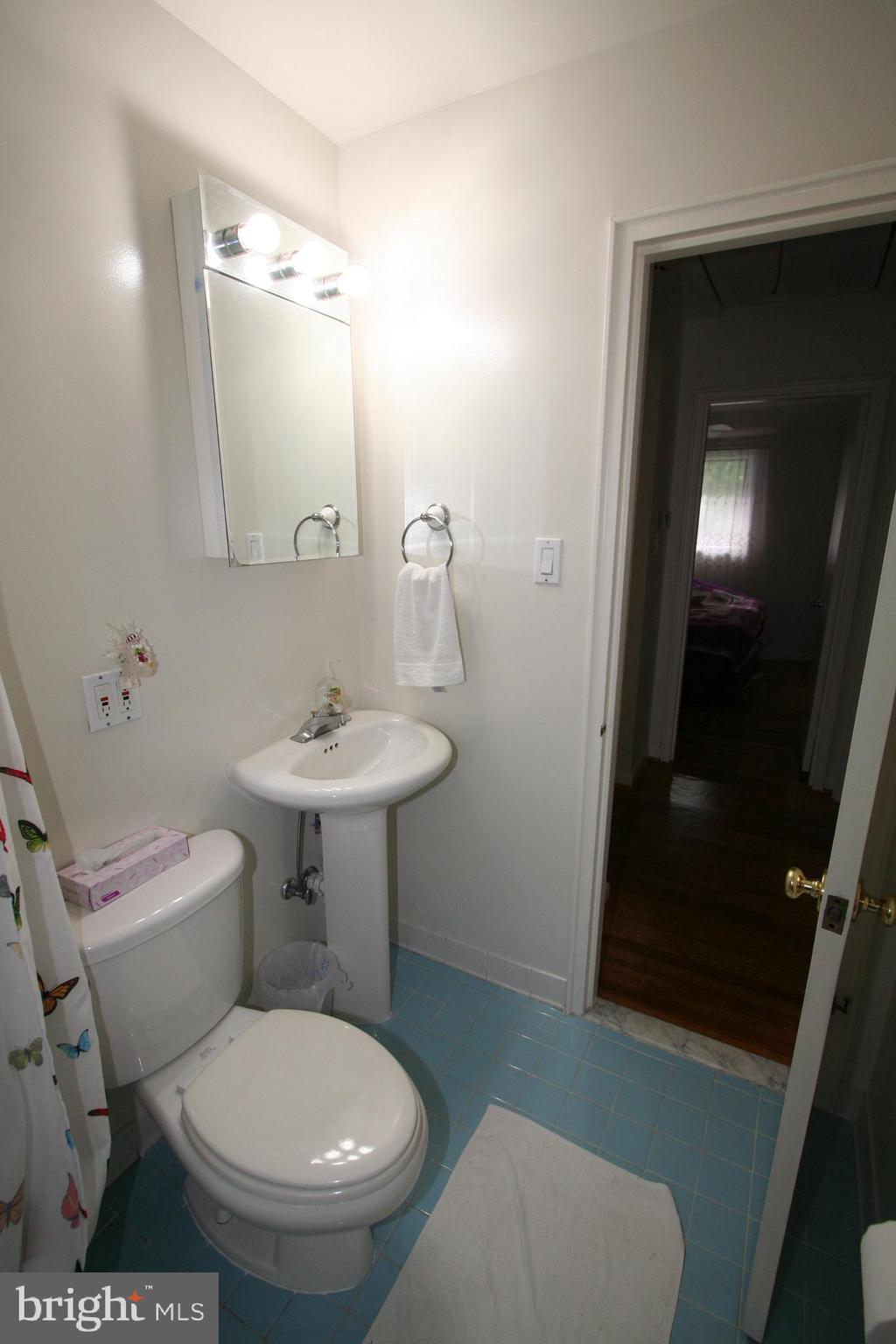 12718 Gould Road Silver Spring, MD 20906 - Photo 26 of 55 a white toilet sitting next to a bathroom sink