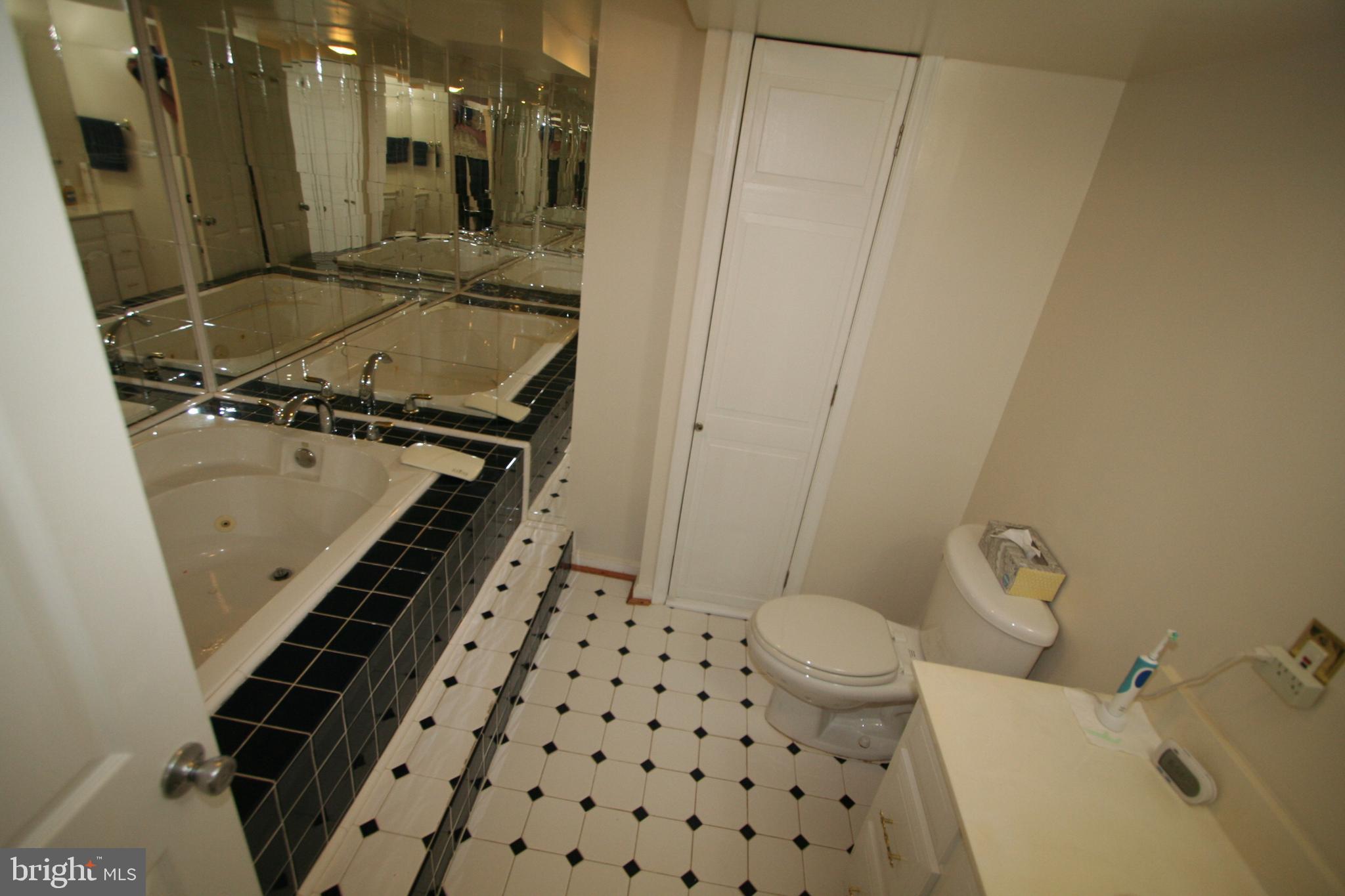12718 Gould Road Silver Spring, MD 20906 - Photo 37 of 55 a bathroom with a granite countertop sink mirror vanity and toilet