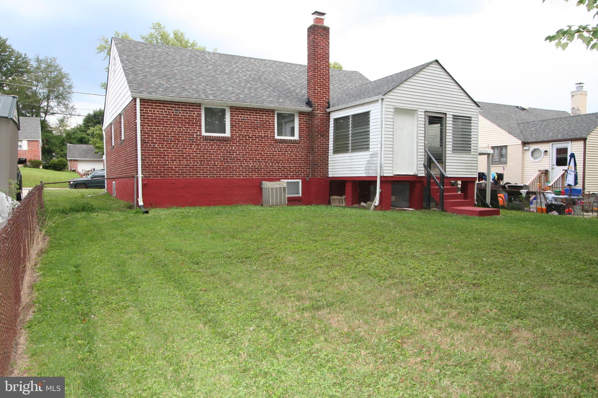 12718 Gould Road Silver Spring, MD 20906 - Photo 44 of 55 a front view of a house with a yard and garage