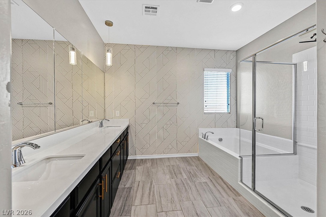 1106 Langston Ranch Avenue Henderson, NV 89002 - Photo 19 of 36 Dual vanity with an expansive mirror anchors this well-lit primary bathroom.