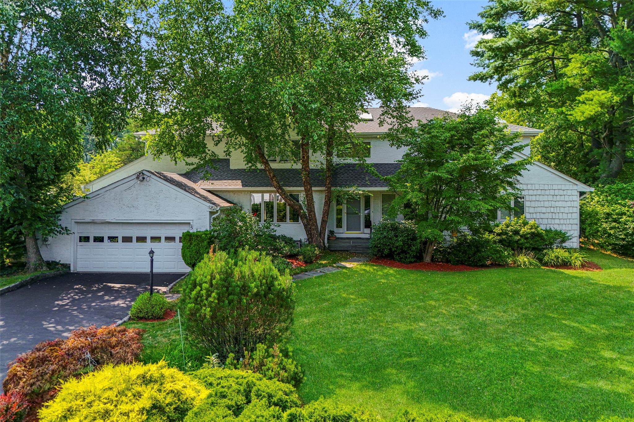 5 Wagon Wheel Road Mamaroneck, NY 10543 - Photo 1 of 1 Obstructed view of property featuring a garage and a front yard