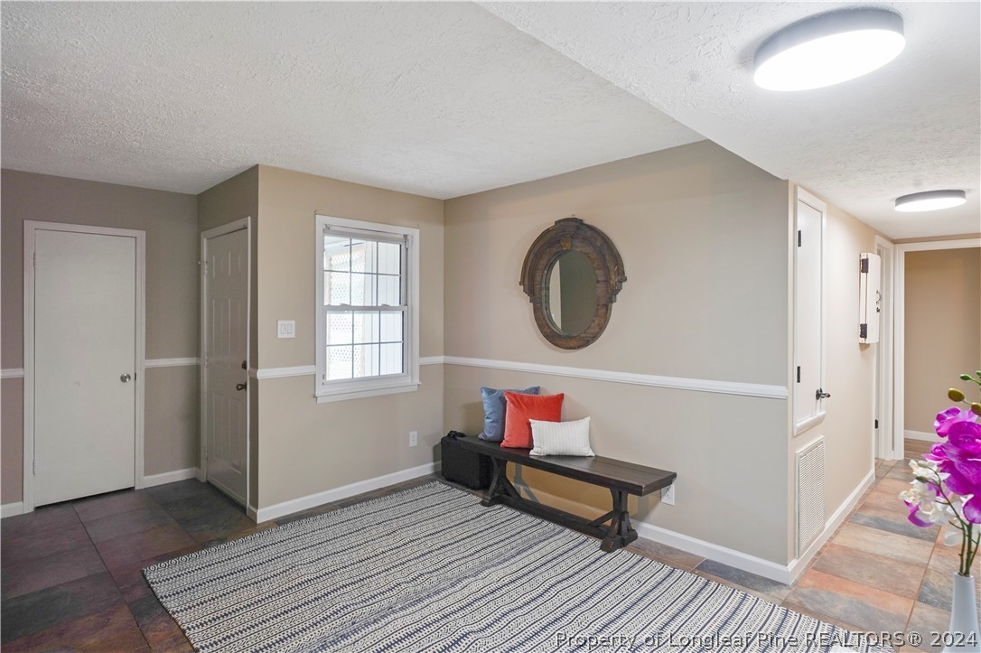 6481 Green Meadow Road Fayetteville, NC 28304 - Photo 20 of 33 a living room with furniture and a wooden floor