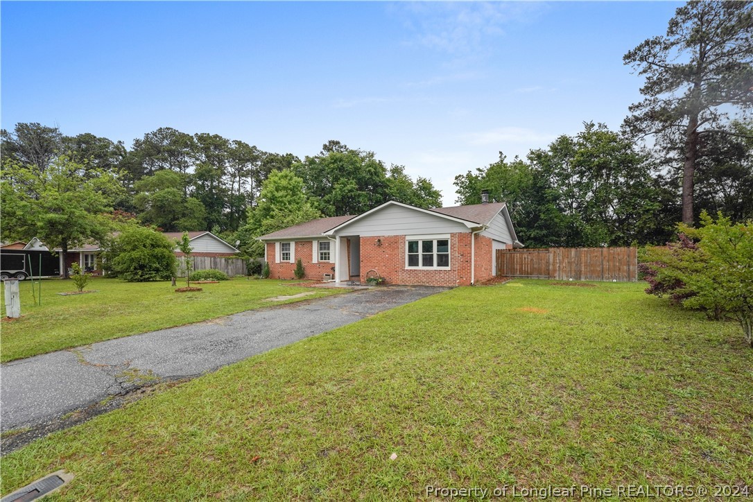 6481 Green Meadow Road Fayetteville, NC 28304 - Photo 2 of 33 a front view of a house with garden