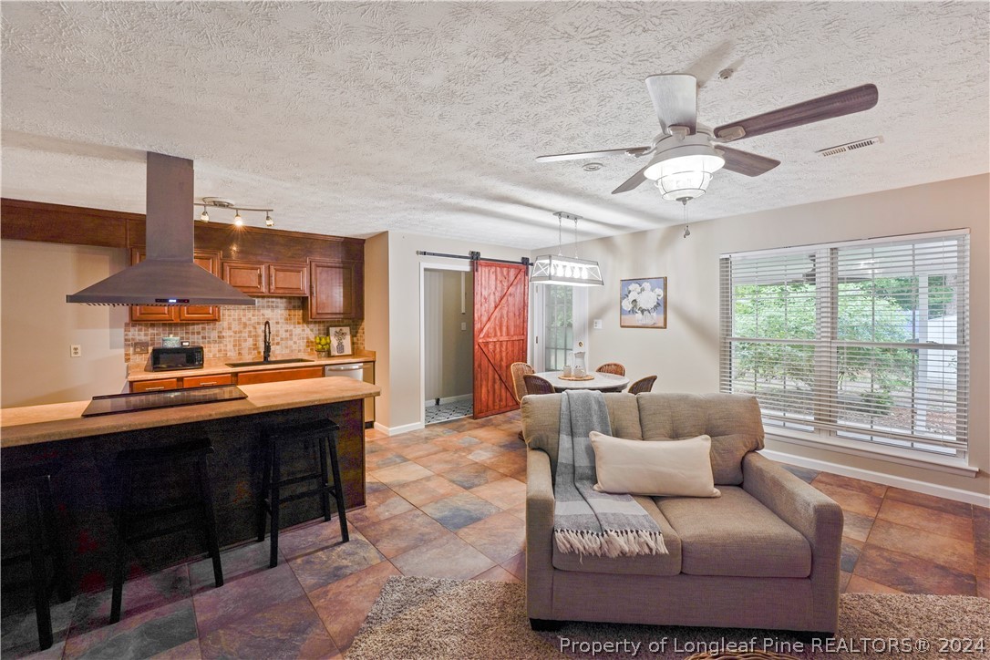 6481 Green Meadow Road Fayetteville, NC 28304 - Photo 21 of 33 a living room with furniture and a large window