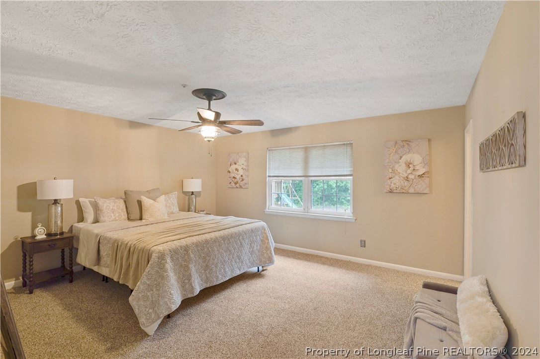6481 Green Meadow Road Fayetteville, NC 28304 - Photo 23 of 33 a bedroom with a bed and window