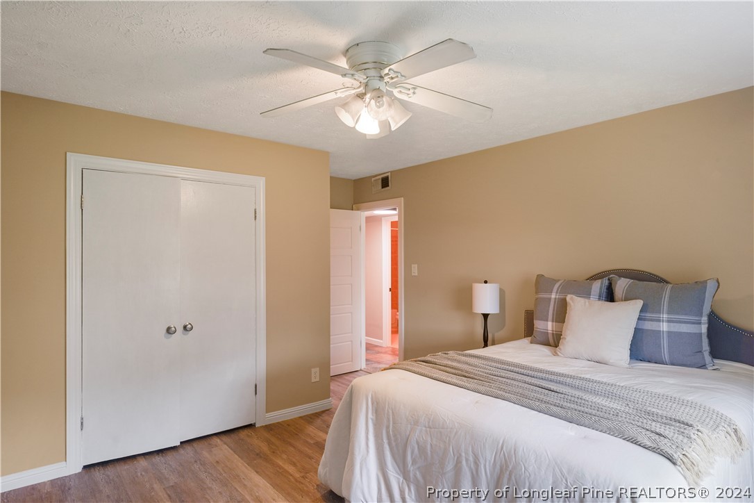 6481 Green Meadow Road Fayetteville, NC 28304 - Photo 30 of 33 a bedroom with a bed and a ceiling fan