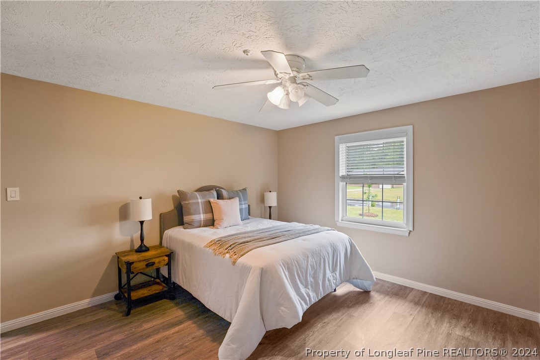 6481 Green Meadow Road Fayetteville, NC 28304 - Photo 31 of 33 a bedroom with a bed and a window