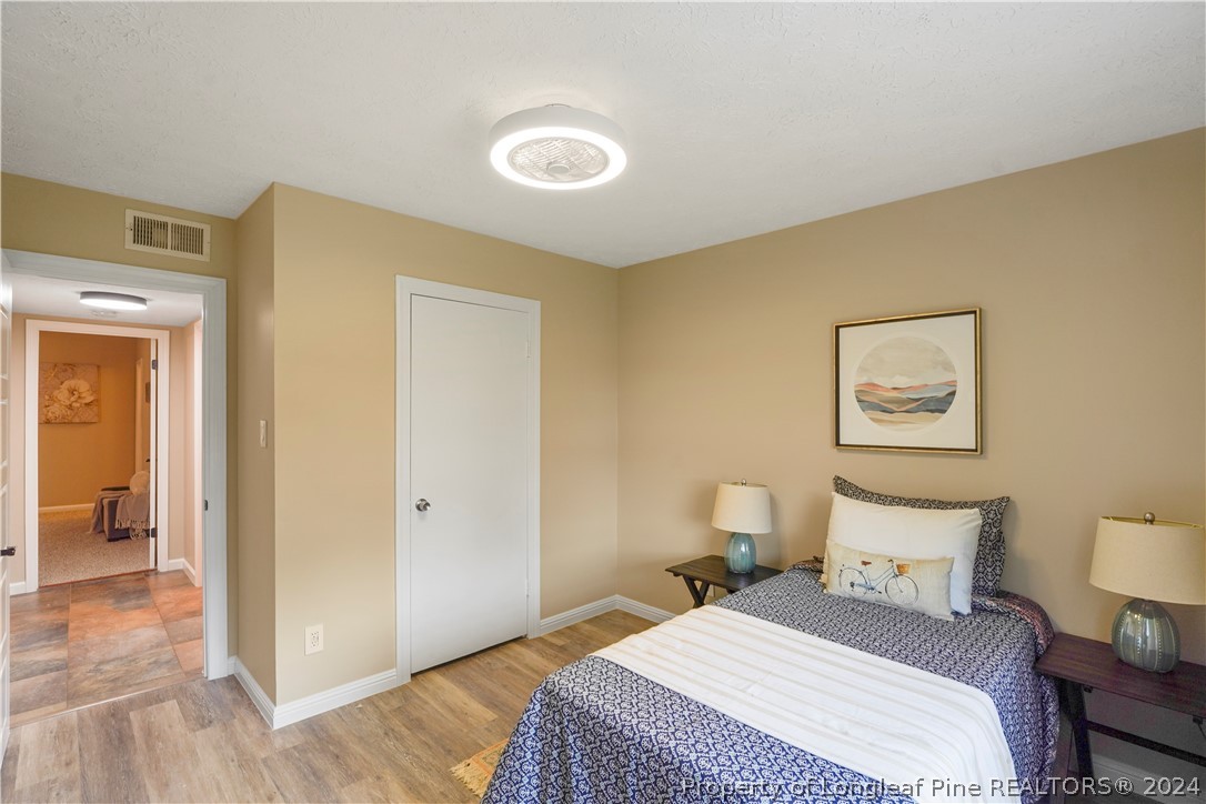 6481 Green Meadow Road Fayetteville, NC 28304 - Photo 33 of 33 a bedroom with a bed and wooden floor