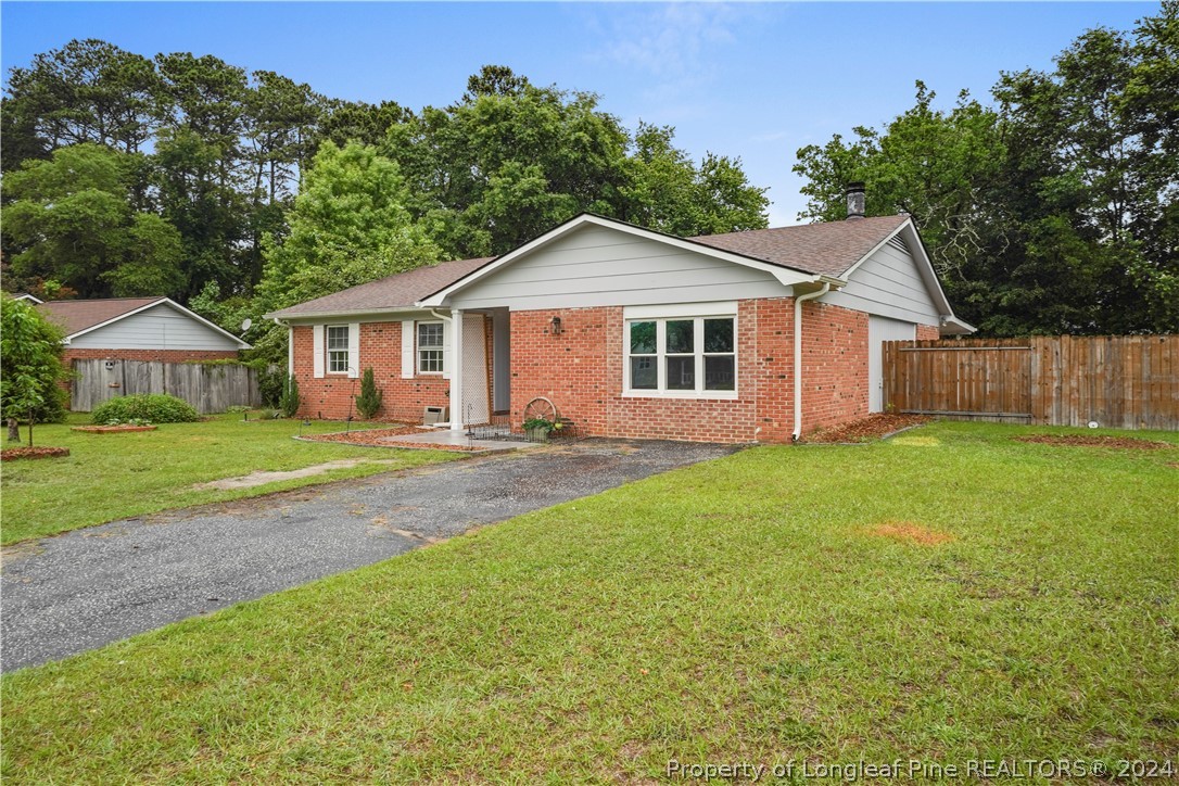 6481 Green Meadow Road Fayetteville, NC 28304 - Photo 4 of 33 a front view of a house with yard