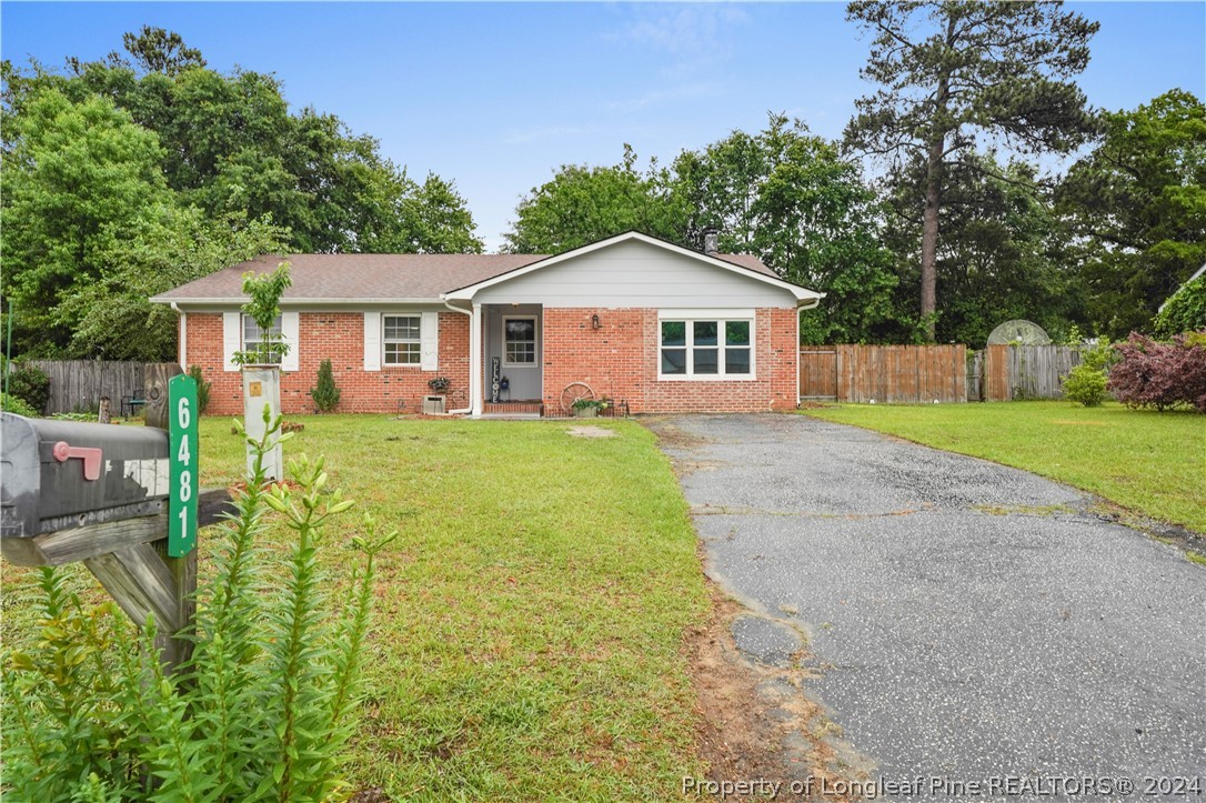 6481 Green Meadow Road Fayetteville, NC 28304 - Photo 5 of 33 a view of a house with a yard and fence