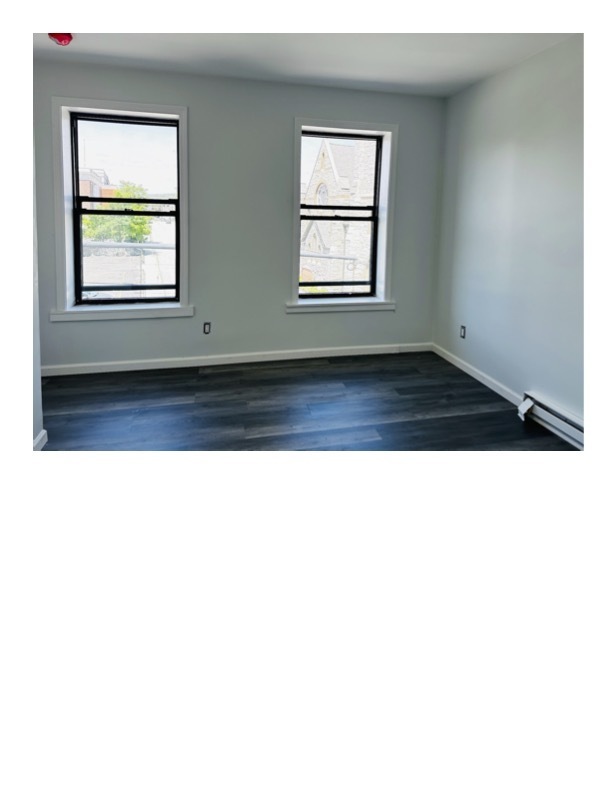 63 Water Street, Unit 33 Torrington, CT 06790 - Photo 3 of 5 a view of an empty room with wooden floor and a window