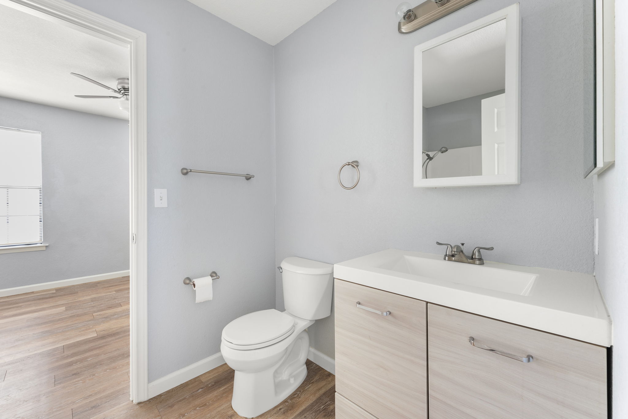 3802 Foust Trail, Unit A Georgetown, TX 78628 - Photo 25 of 34 An inviting bathroom offers a bright vanity, modern fixtures, and sleek wood-look flooring.