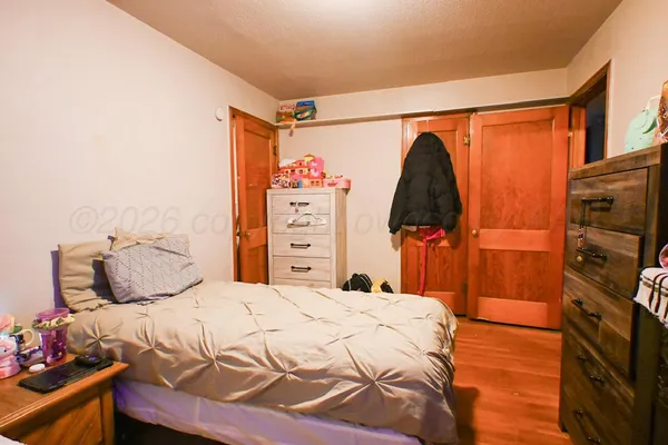 a bedroom with a bed and a closet