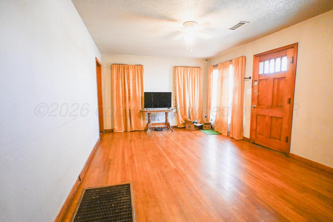 1313 Southwest 15th Avenue Amarillo, TX 79102 - Photo 2 of 15 a view of a room with wooden floor and furniture
