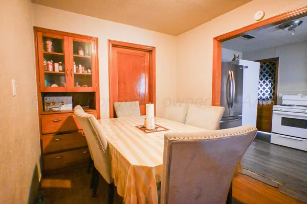 a dining room with furniture and wooden floor