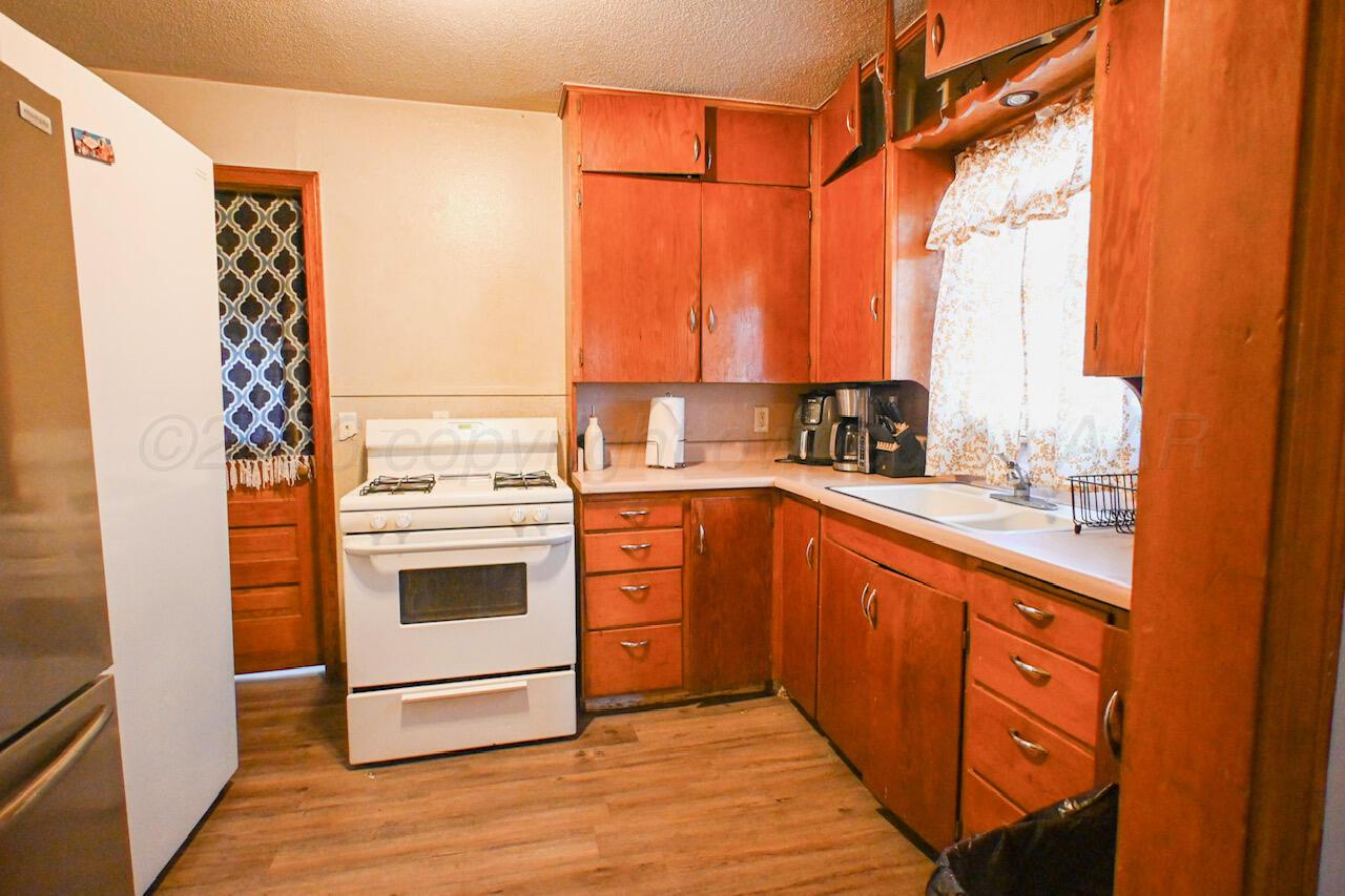 1313 Southwest 15th Avenue Amarillo, TX 79102 - Photo 10 of 15 a kitchen with stainless steel appliances a stove sink and cabinets