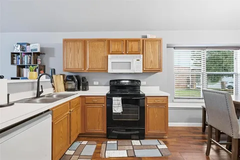 a kitchen with granite countertop a stove and a sink