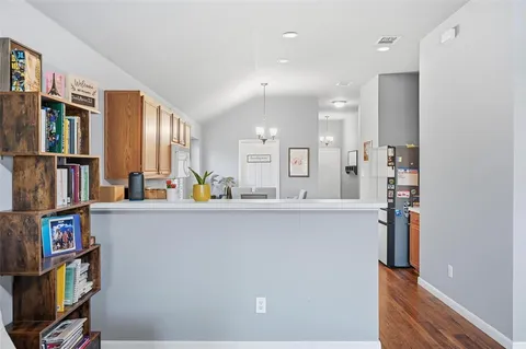 a living room with lots of furniture and a book shelf
