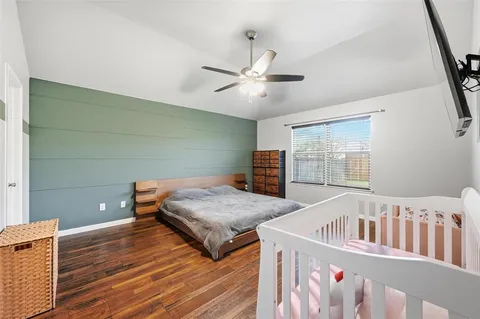 a bedroom with two beds and a chandelier