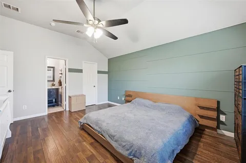 a bedroom with bed and wooden floor
