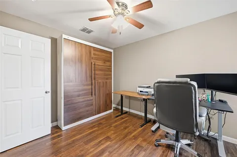 a view of a workspace with furniture and wooden floor