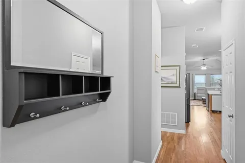 a view of an empty room with wooden floor and a cabinet