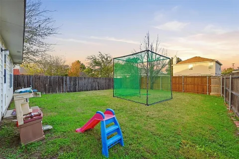 a view of a play ground in front of a house