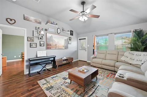 a living room with furniture a rug and a window