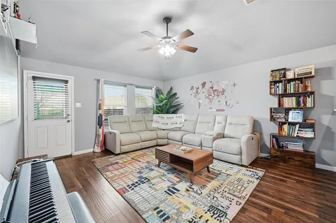a living room with furniture and wooden floor