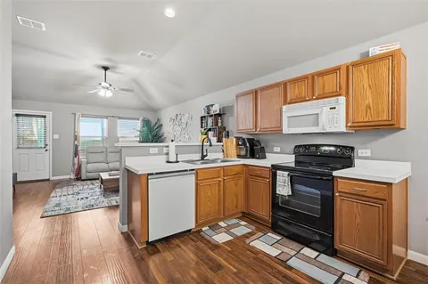a kitchen with a stove a sink and a microwave