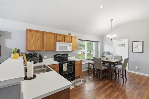 a view of a dining room with furniture and a window