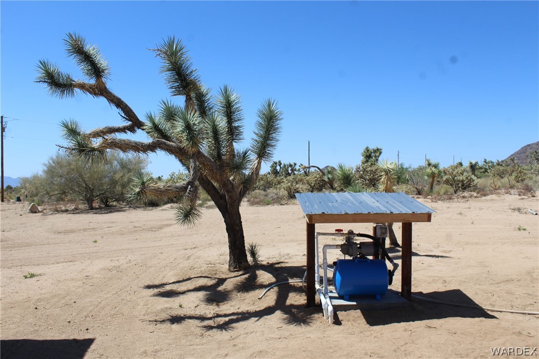11722 Suzette Road Yucca, AZ 86438 - Photo 22 of 29 a view of a house with a yard and sitting area