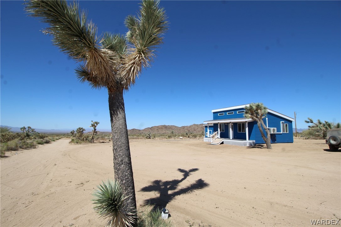 11722 Suzette Road Yucca, AZ 86438 - Photo 5 of 29 a view of a house with a yard covered with snow